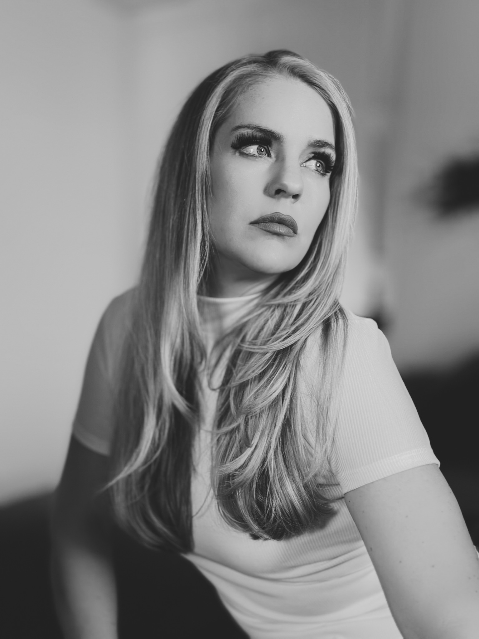 Jennifer Hopper, singer-songwriter, in a black-and-white seated portrait